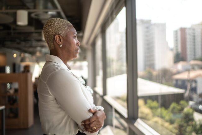 Serious businesswoman looking through the window