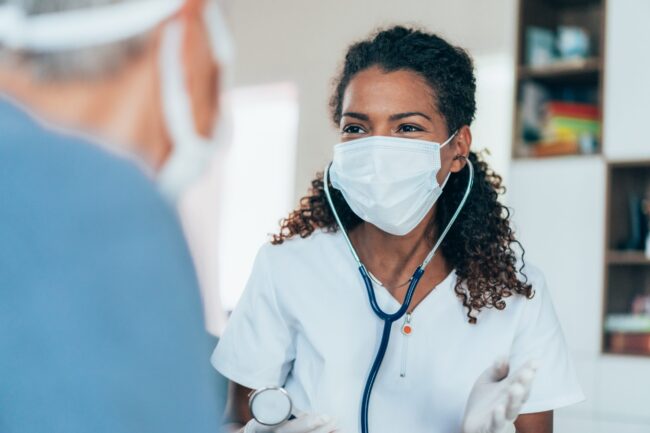 Doctor visiting a senior woman at home