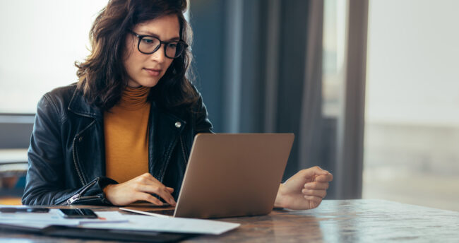 Woman looking over compliance materials. Woman looking over compliance materials.