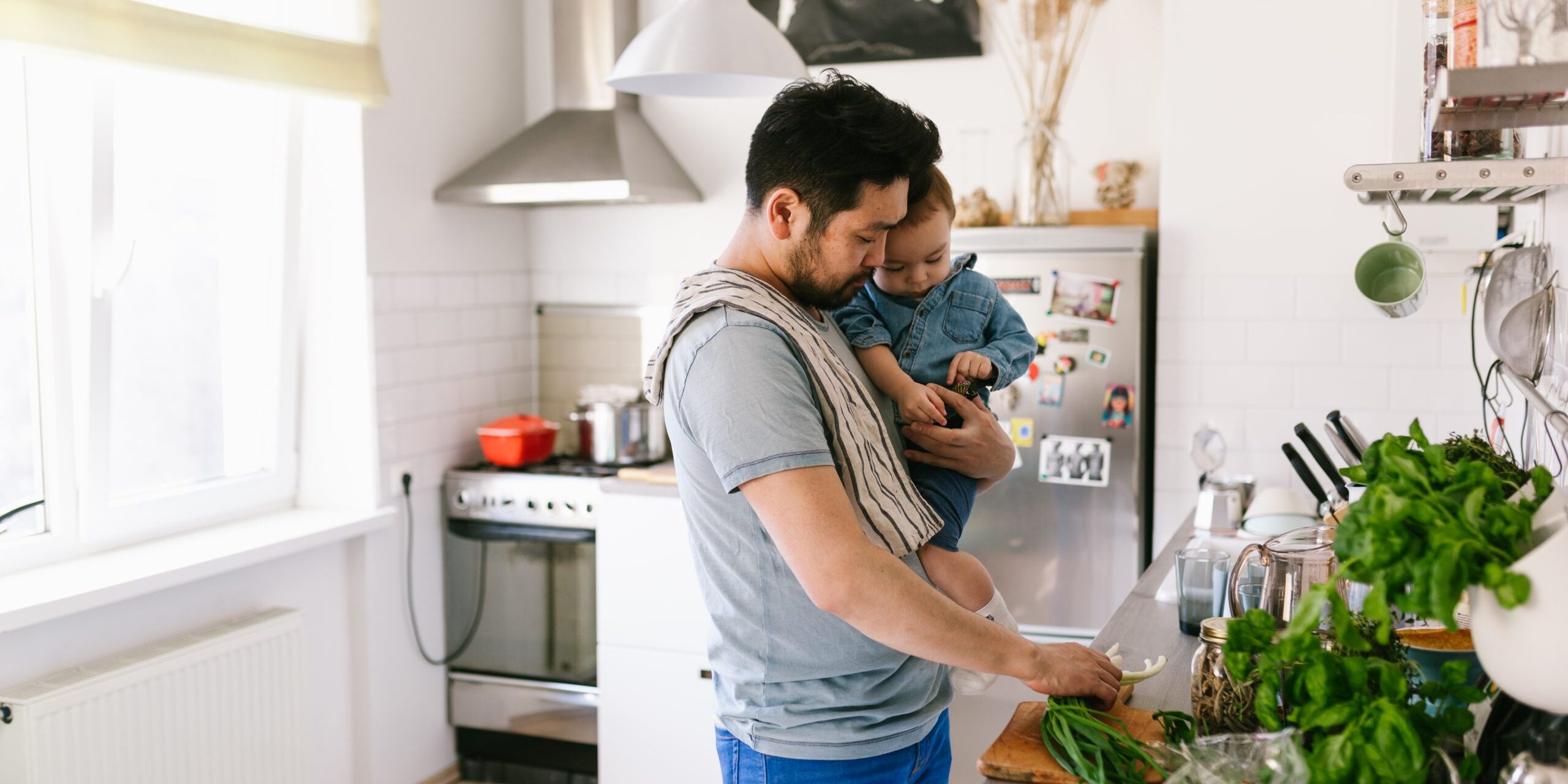 Asian man cooking with his son