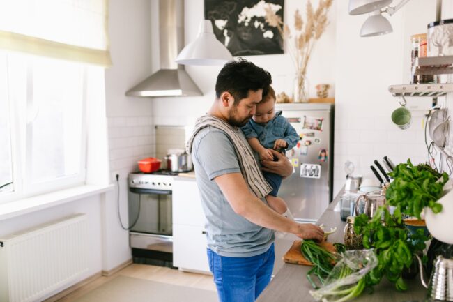 Asian man cooking with his son