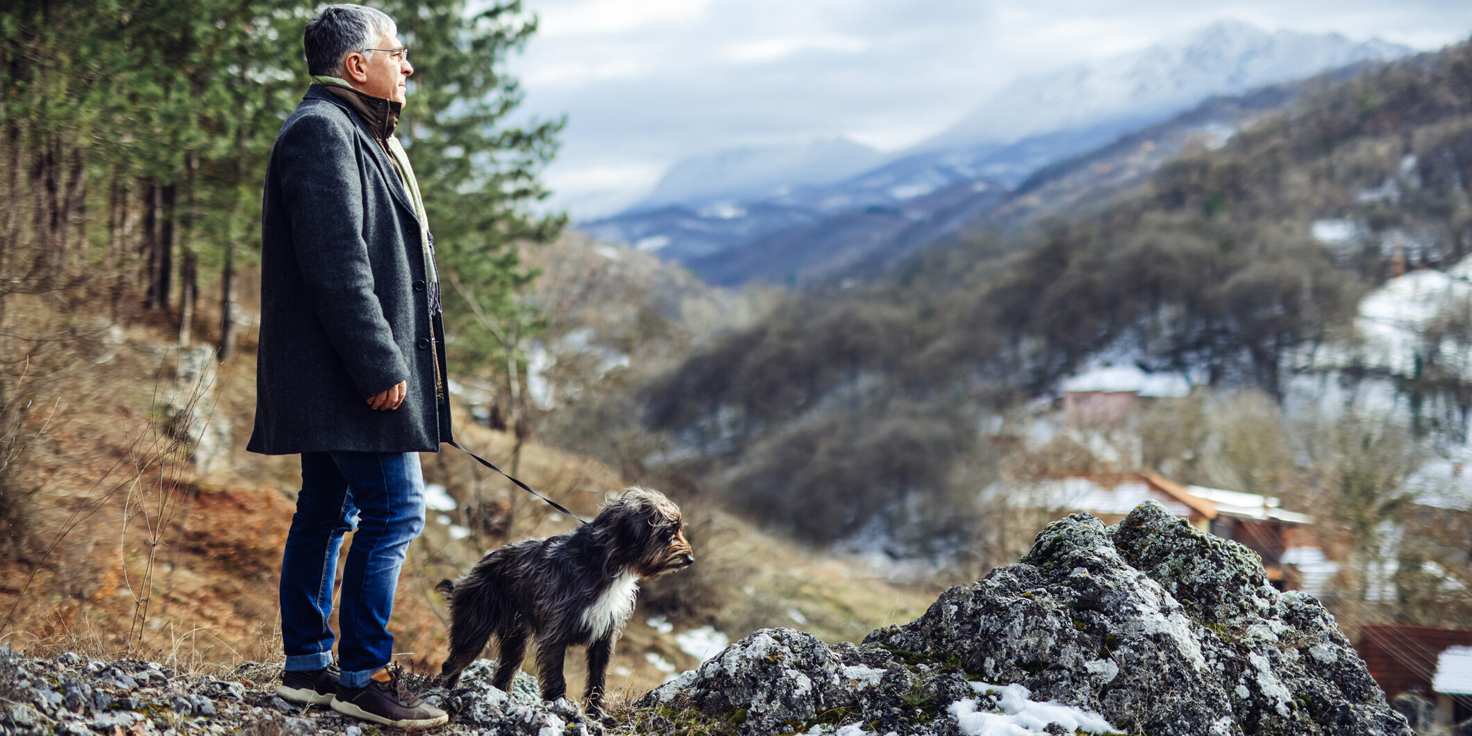 Man walking dog in nature.