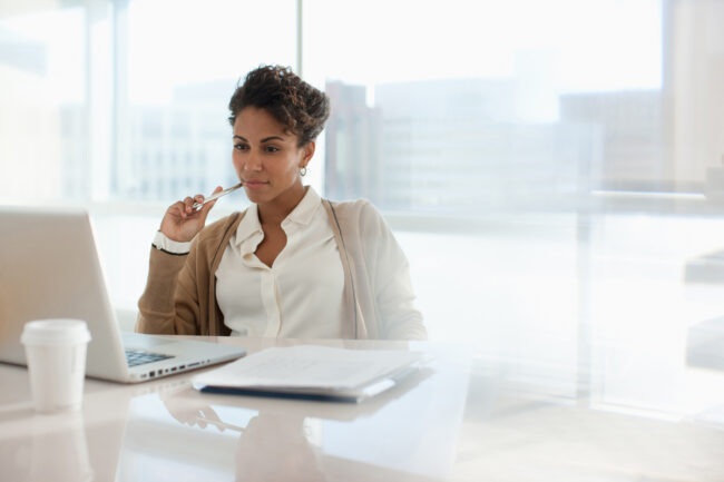 Woman filling out paperwork for compliance. Woman filling out paperwork for compliance.