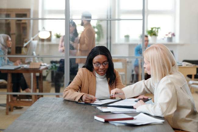 Mature employer explaining terms of contract to applicant