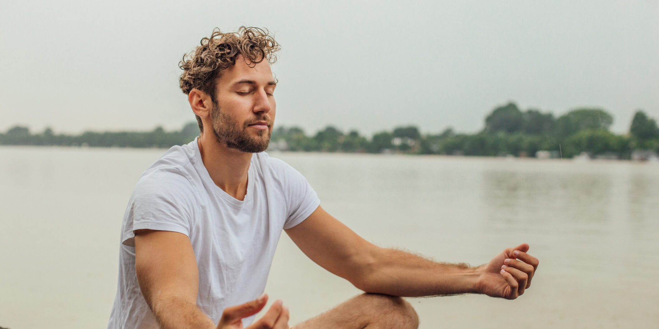Fit man exercising yoga Young man doing yoga outdoors