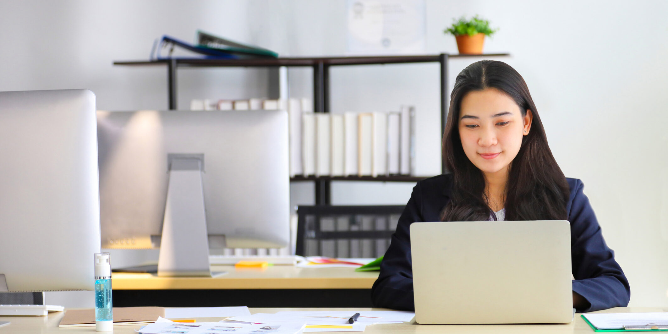 Asian businesswoman working in office using laptop computer with formal wearing