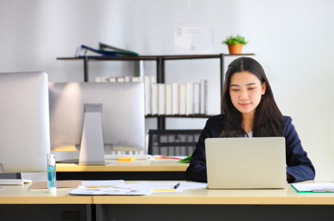 Asian businesswoman working in office using laptop computer with formal wearing