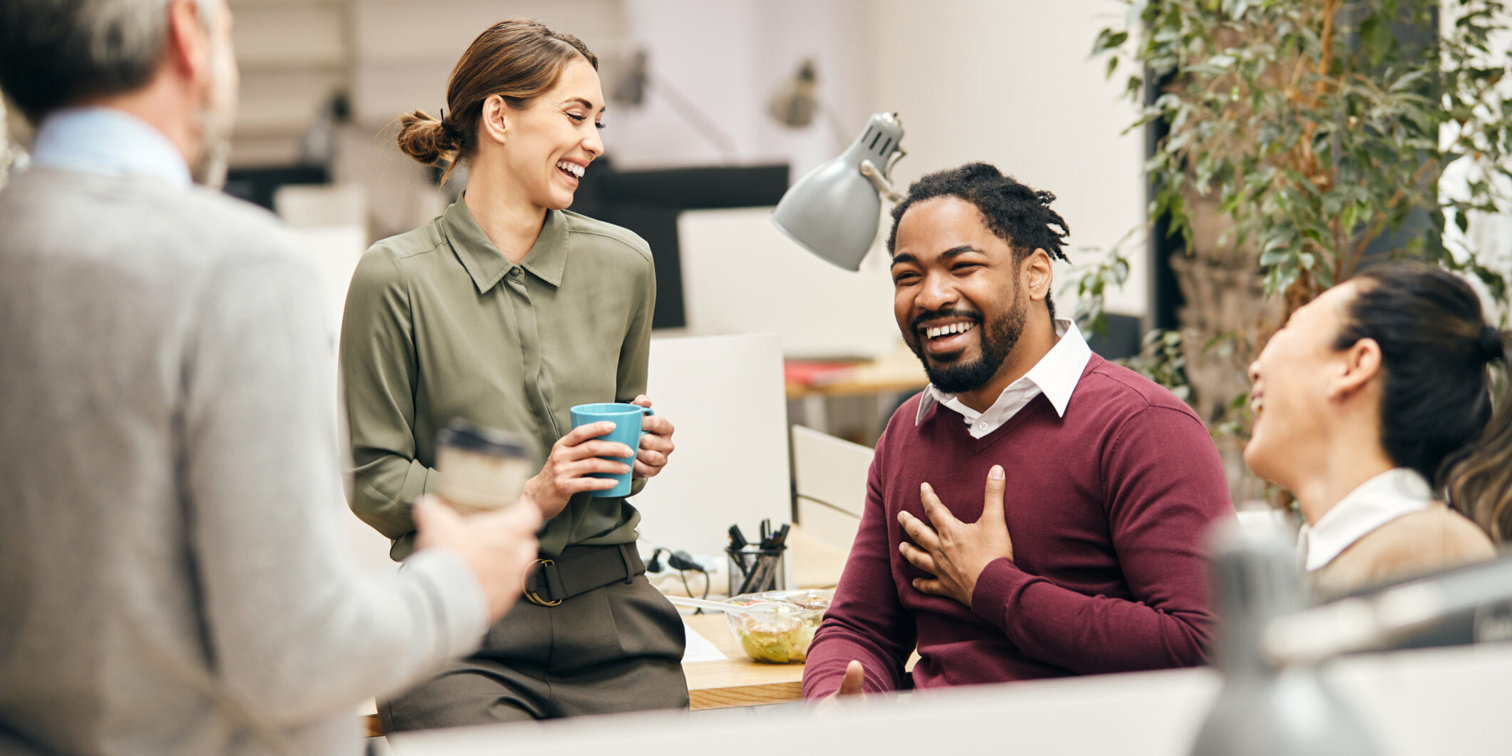 Happy business team having fun while talking on their coffee break in the office. Happy business team having fun while talking on their coffee break in the office.