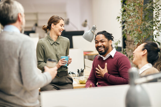 Happy business team having fun while talking on their coffee break in the office. Happy business team having fun while talking on their coffee break in the office.