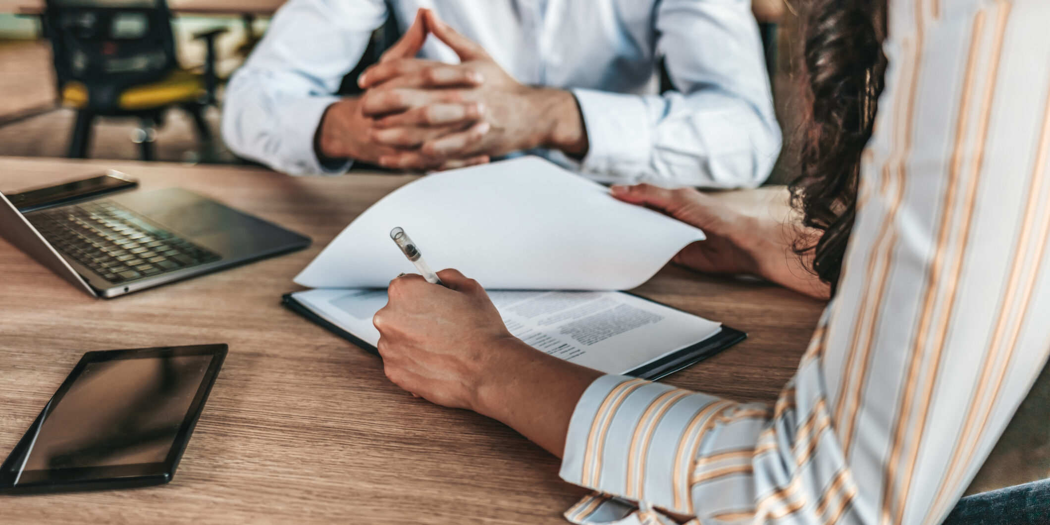 Business people negotiating a contract Business people signing papers and meeting deadlines