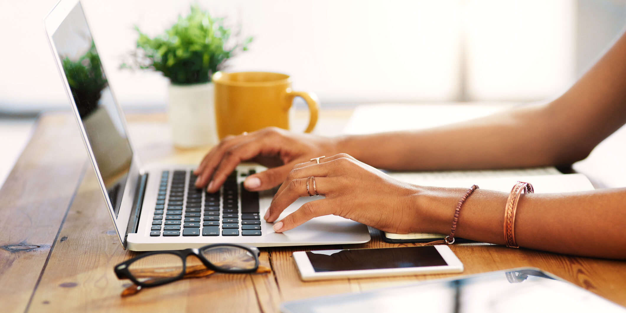 I love working from home Cropped shot of an unrecognizable businesswoman sitting alone and typing on her laptop during the day at home