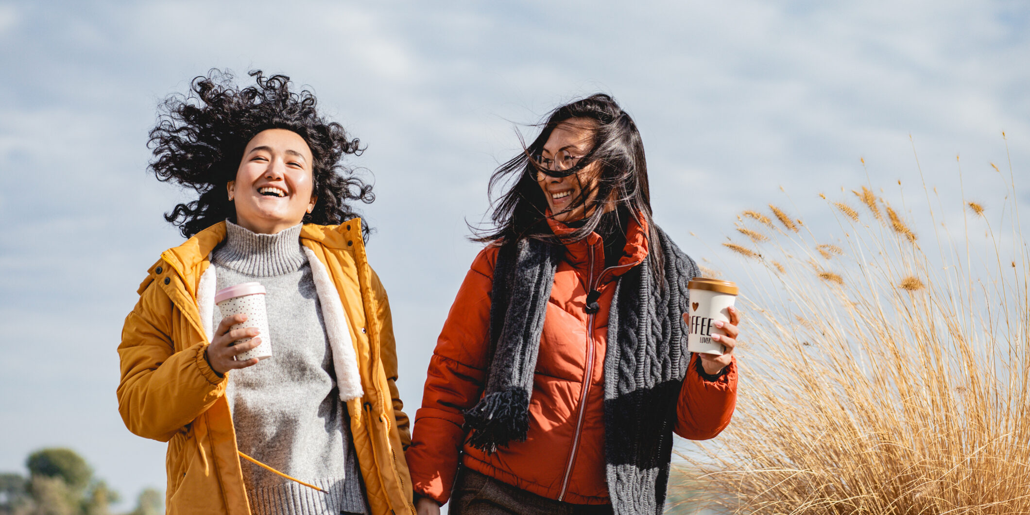 Two Asian female friends are excited outdoors