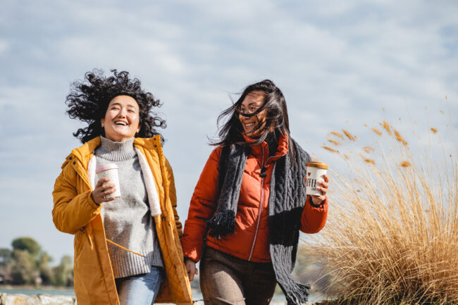 Two Asian female friends are excited outdoors