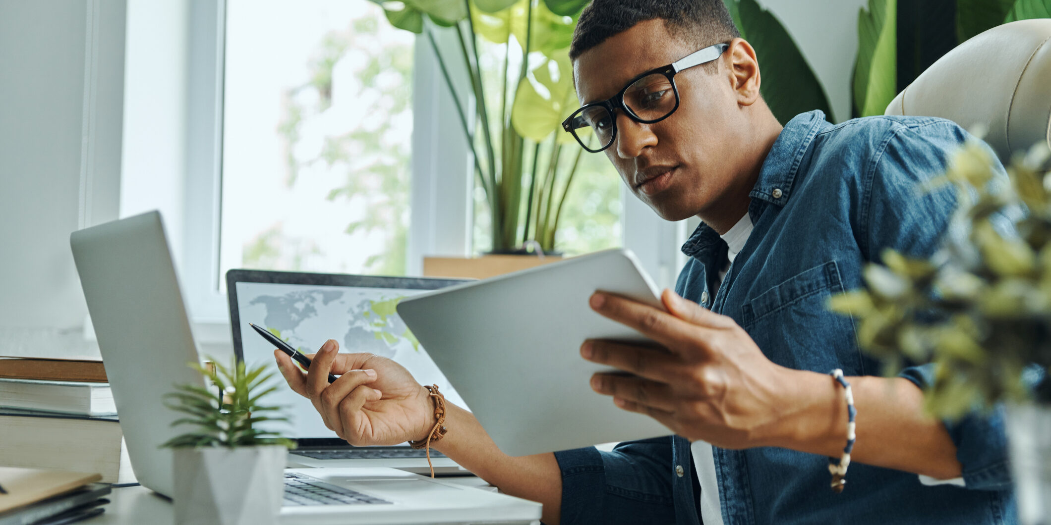 Busy young mixed race man using technologies
