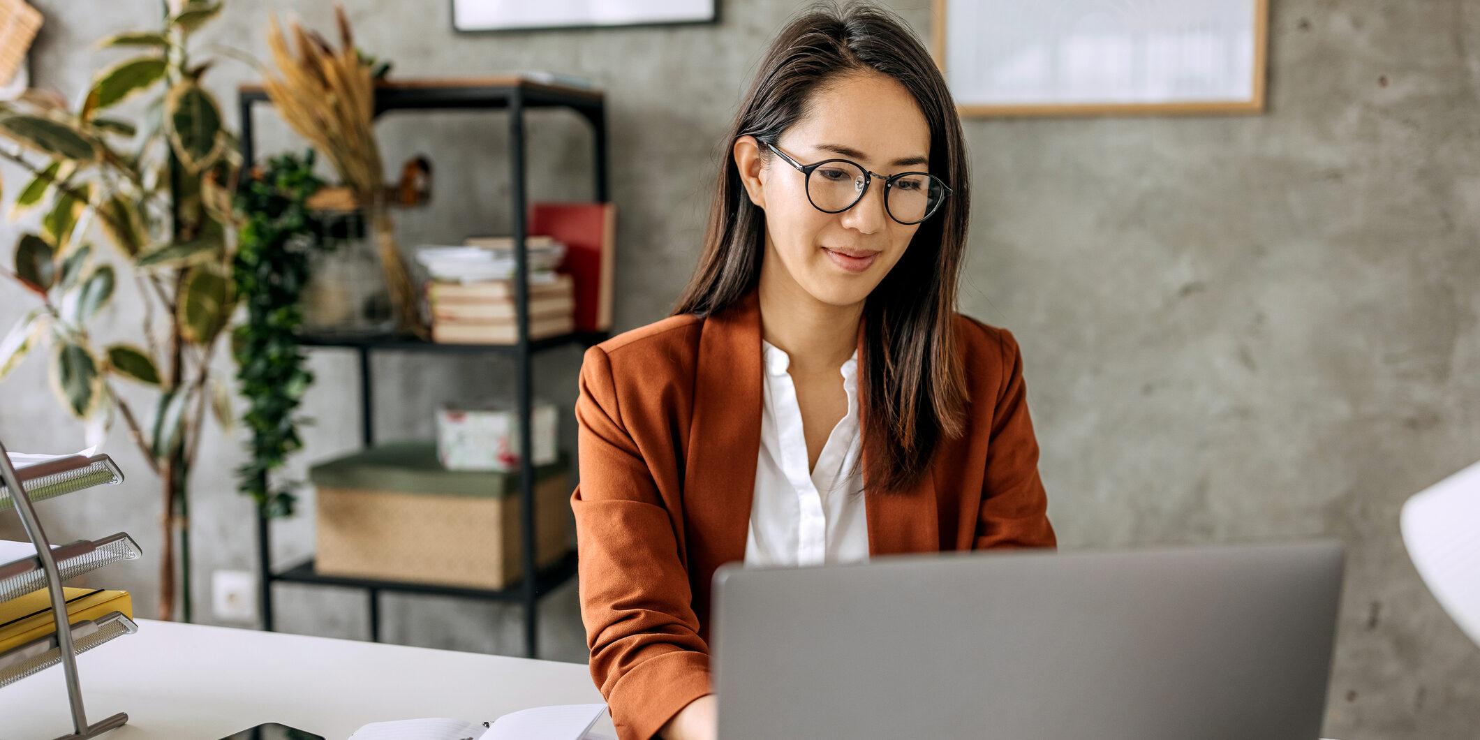 Well dressed beautiful mid adult businesswoman working from home office