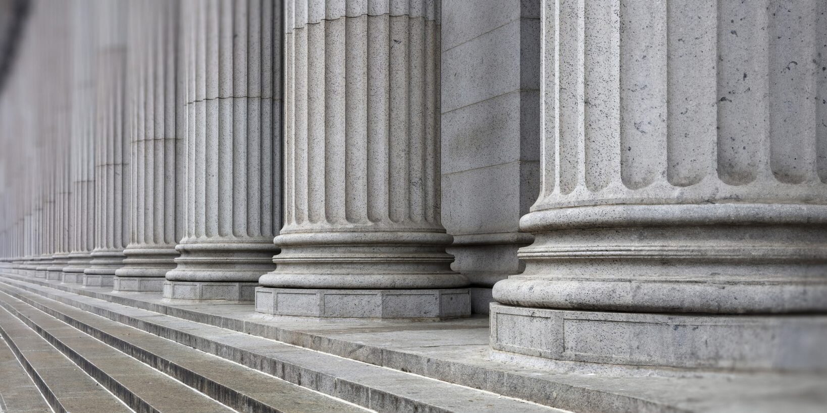 Stone colonnade and stairs detail. Classical pillars row in a building facade