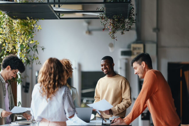 A Group Of Happy Multiethnic Businesspeople Working Together In The Office