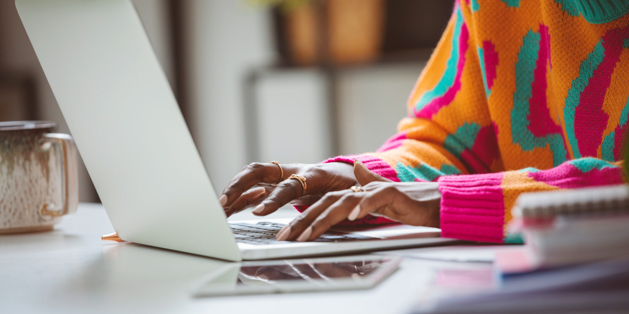 Woman typing on laptop keyboard