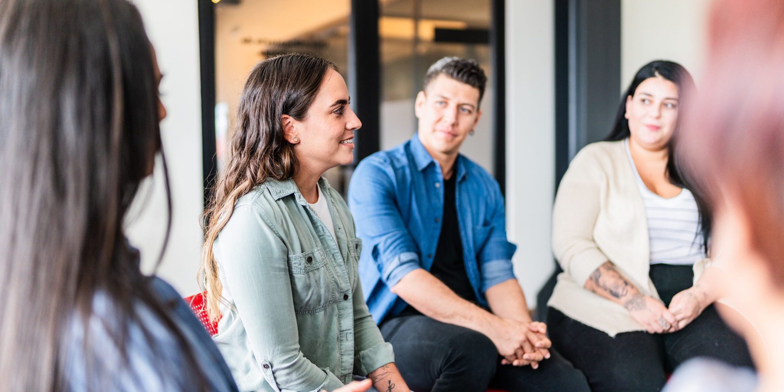 Mid adult woman introducing herself in group therapy at mental health center