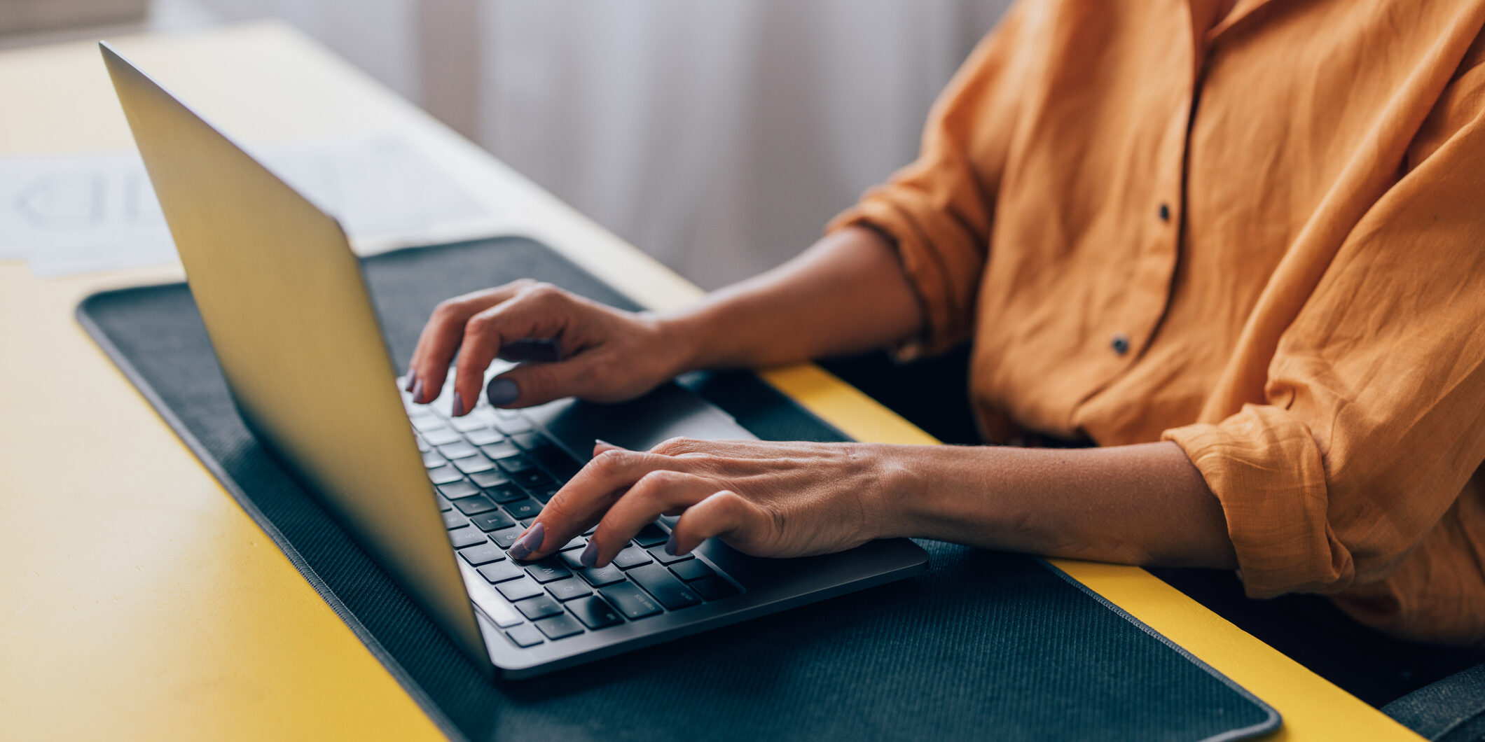 Professional Woman Working on Laptop at Modern Workspace