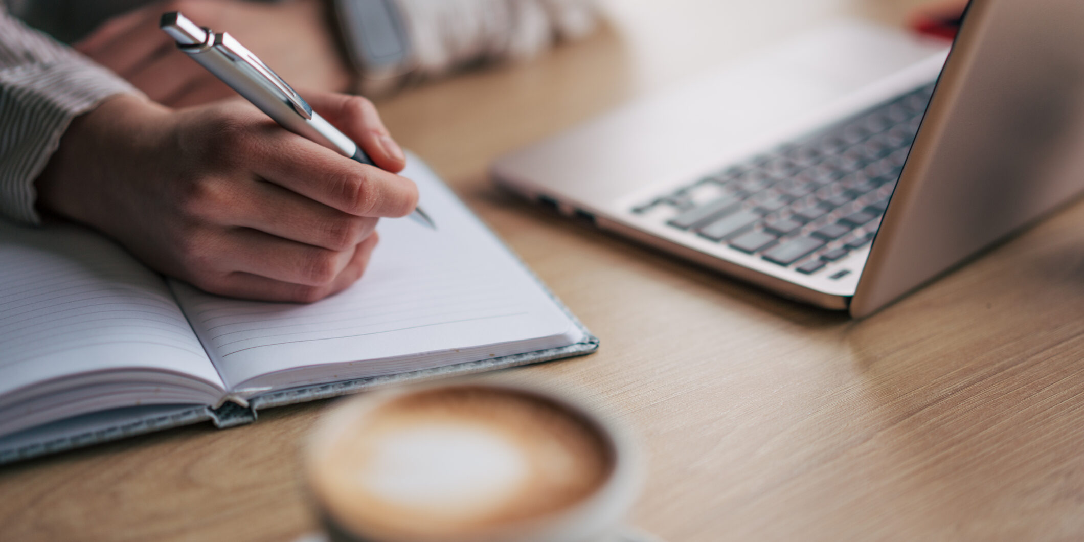 Close up photo of female hand writting down something