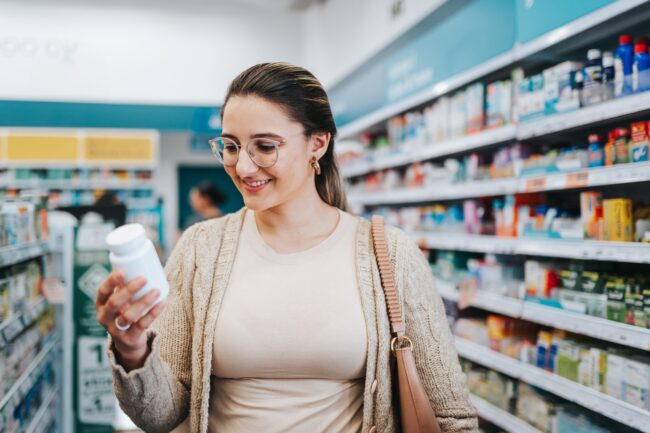 Woman choosing supplements at the pharmacy