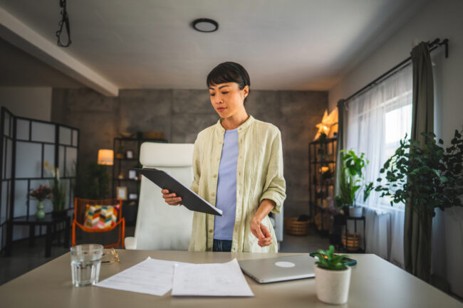 Mature japanese woman work from home on clipboard