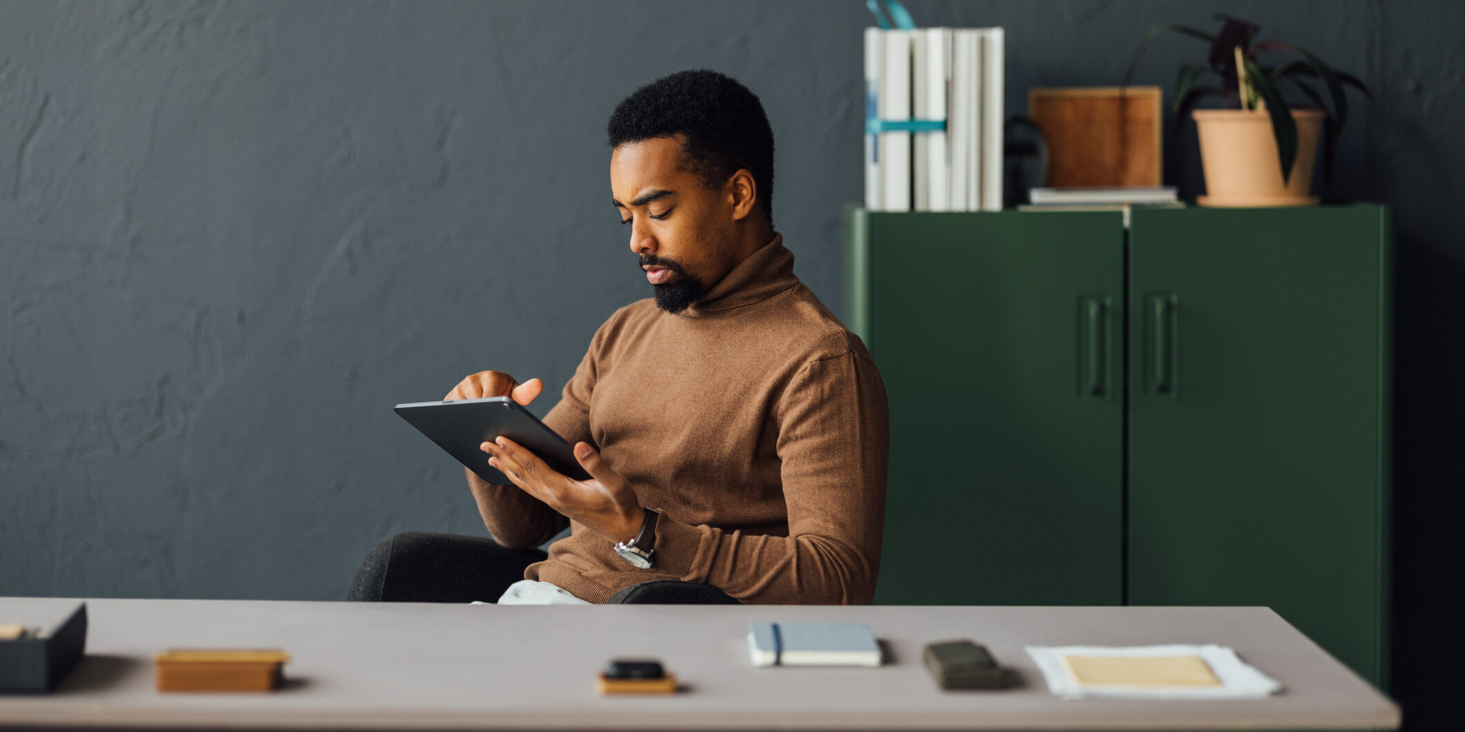 Young Man Working on Tablet in Modern Office Setting