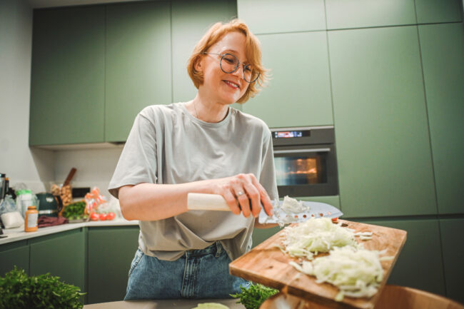 woman preparing salad in the kitchen woman chopping onions